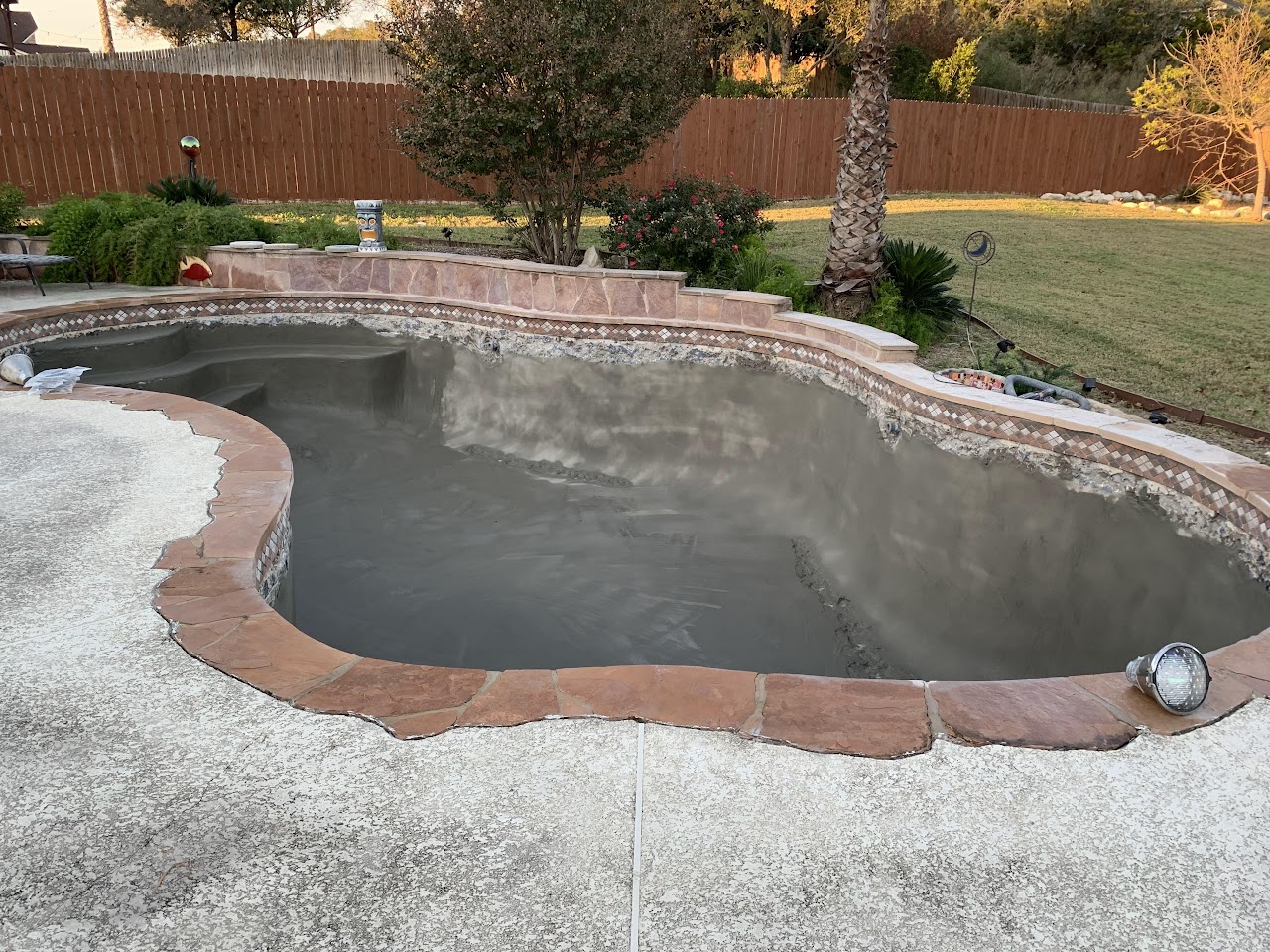 Dark finished pool filling with water